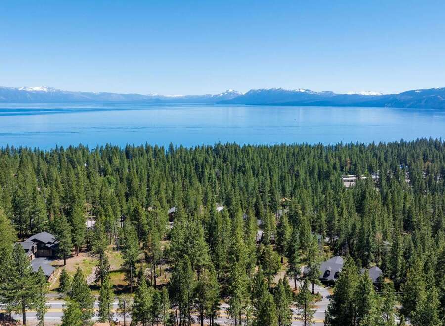 Experience breathtaking lake and mountain views from this stunning property nestled amongst a dense forest of pine trees.