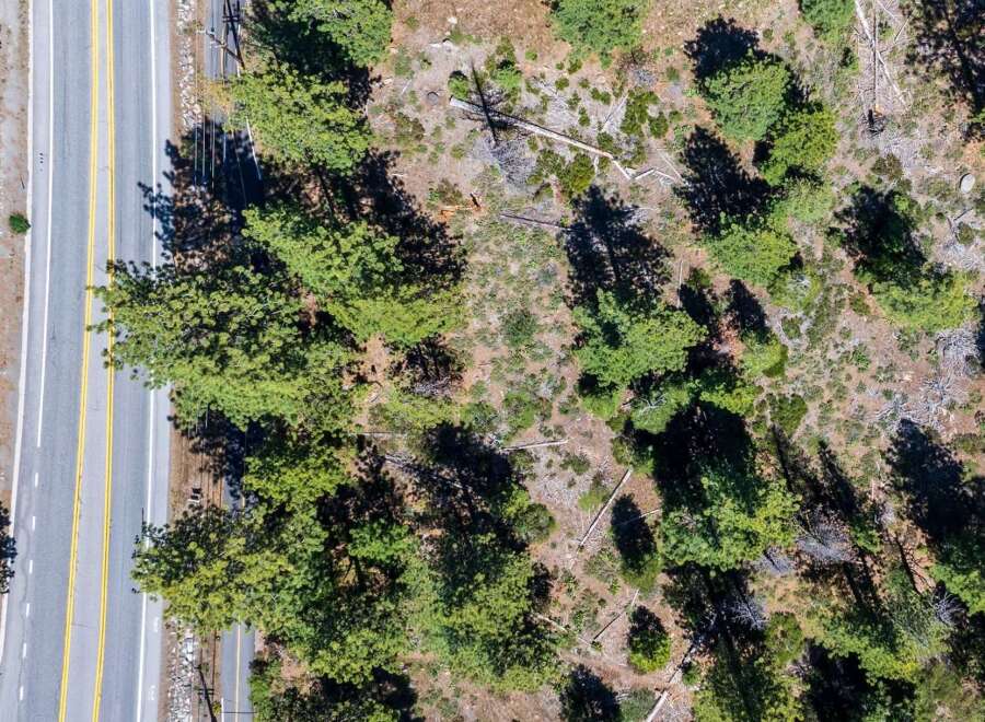Discover this prime real estate opportunity featuring a paved road with clear yellow lane markings, ideal for easy access.