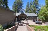 Discover this stunning mountain retreat featuring a spacious paver patio perfect for outdoor entertaining, complete with multiple seating areas and dining sets.