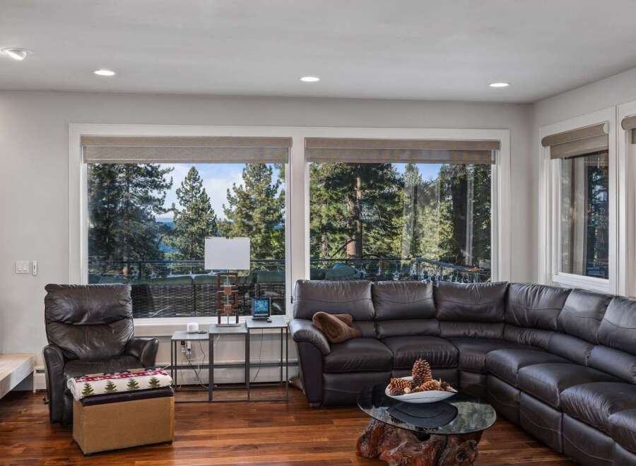 Experience breathtaking views from this stunning living room, featuring a spacious sectional sofa perfect for relaxation.
