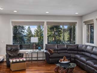 Experience breathtaking views from this stunning living room, featuring a spacious sectional sofa perfect for relaxation.