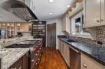 Experience culinary excellence in this gourmet kitchen, featuring a professional-grade gas range and a spacious granite island perfect for meal prep and entertaining.