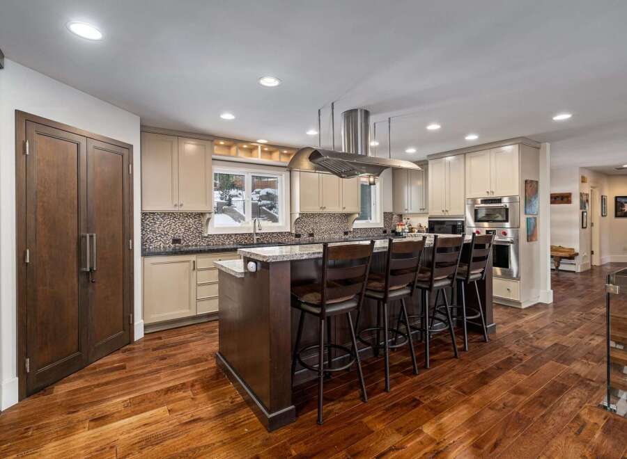 Experience luxury in this stunning kitchen, featuring a large island with bar seating perfect for entertaining.