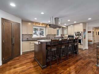Experience luxury in this stunning kitchen, featuring a large island with bar seating perfect for entertaining.