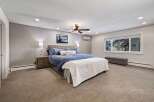 Experience ultimate comfort in this spacious master bedroom, featuring a luxurious king-sized bed adorned with plush blue bedding.