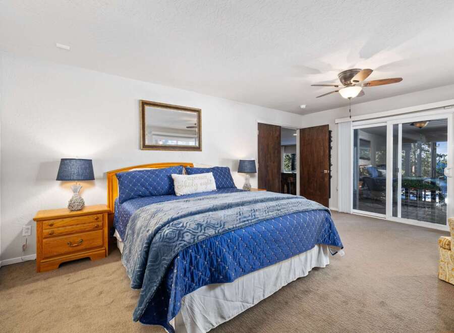 Experience comfort and style in this inviting bedroom, featuring a plush blue comforter and a decorative accent pillow.