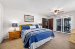 Experience comfort and style in this inviting bedroom, featuring a plush blue comforter and a decorative accent pillow.