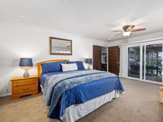 Experience comfort and style in this inviting bedroom, featuring a plush blue comforter and a decorative accent pillow.