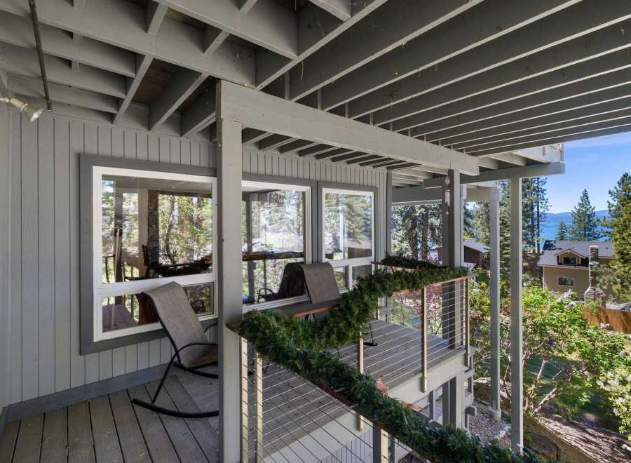 Enjoy breathtaking lake views from this stunning property's expansive deck, perfect for outdoor entertaining or quiet relaxation.