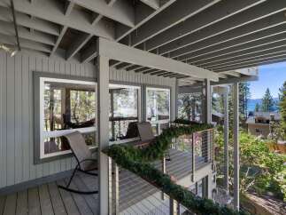Enjoy breathtaking lake views from this stunning property's expansive deck, perfect for outdoor entertaining or quiet relaxation.