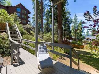 Enjoy the serene mountain setting from this spacious deck, perfect for outdoor relaxation.