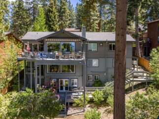 Experience luxury living in this stunning multi-level home, nestled amidst towering pine trees.