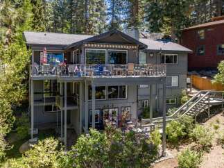 Experience luxury living in this stunning multi-level home, featuring expansive decks perfect for entertaining or enjoying the serene surroundings.