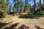 Discover this stunning property nestled amidst towering pine trees and natural rock formations.
