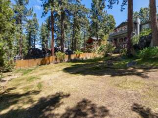 Discover this stunning property nestled amidst towering pine trees and natural rock formations.