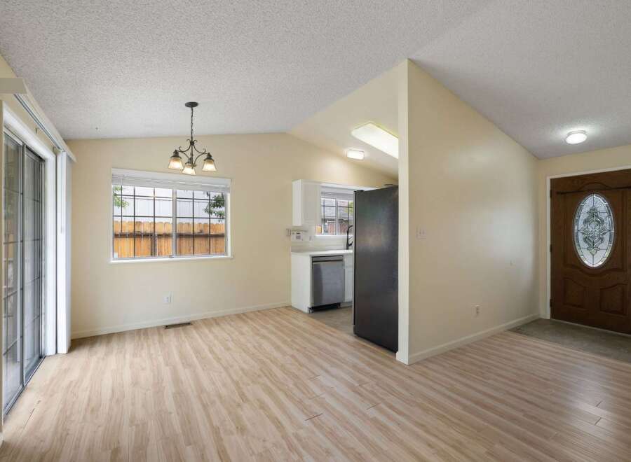 Discover this charming home featuring an open-concept living and dining area with beautiful light wood flooring.