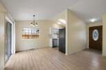 Discover this charming home featuring an open-concept living and dining area with beautiful light wood flooring.