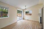 This dining area features a vaulted ceiling with a charming chandelier, creating an open and airy atmosphere.