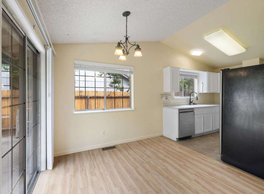 Discover a bright and airy dining area with a sliding glass door leading to the outdoors.