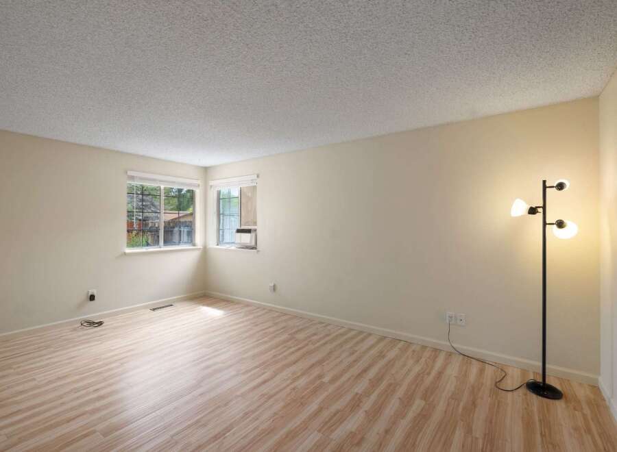 Bright and airy living space featuring a neutral color palette and light wood-look flooring.