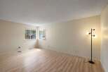 Bright and airy living space featuring a neutral color palette and light wood-look flooring.