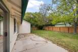 Enjoy outdoor living in this spacious backyard featuring a concrete patio and a well-maintained lawn, perfect for relaxation and recreation.