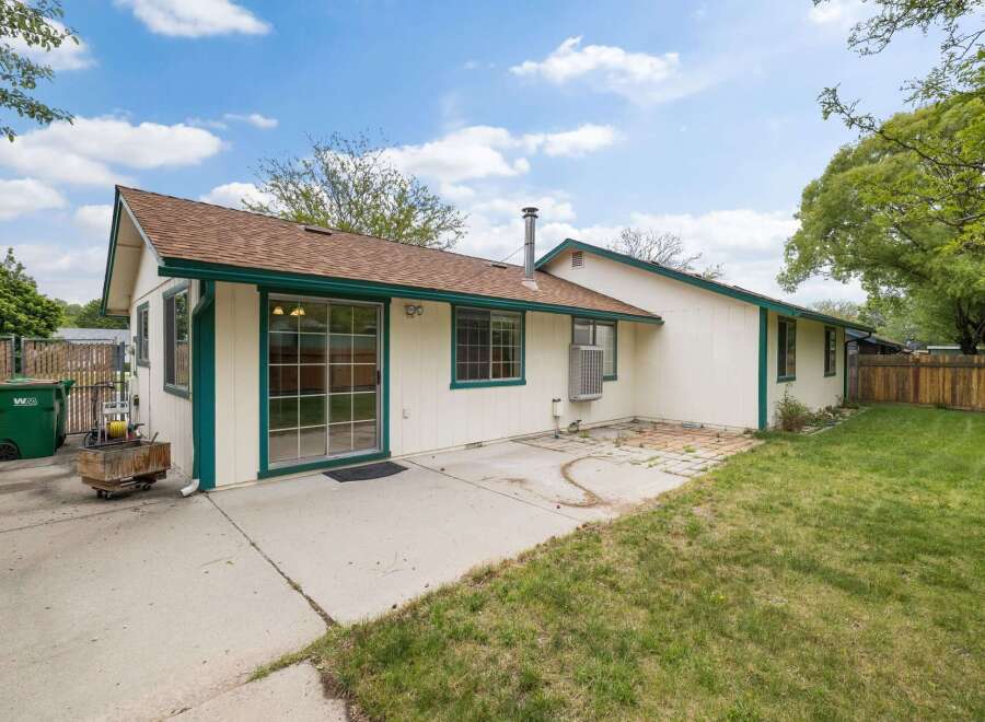 Enjoy outdoor living in this charming home featuring a spacious concrete patio perfect for entertaining.