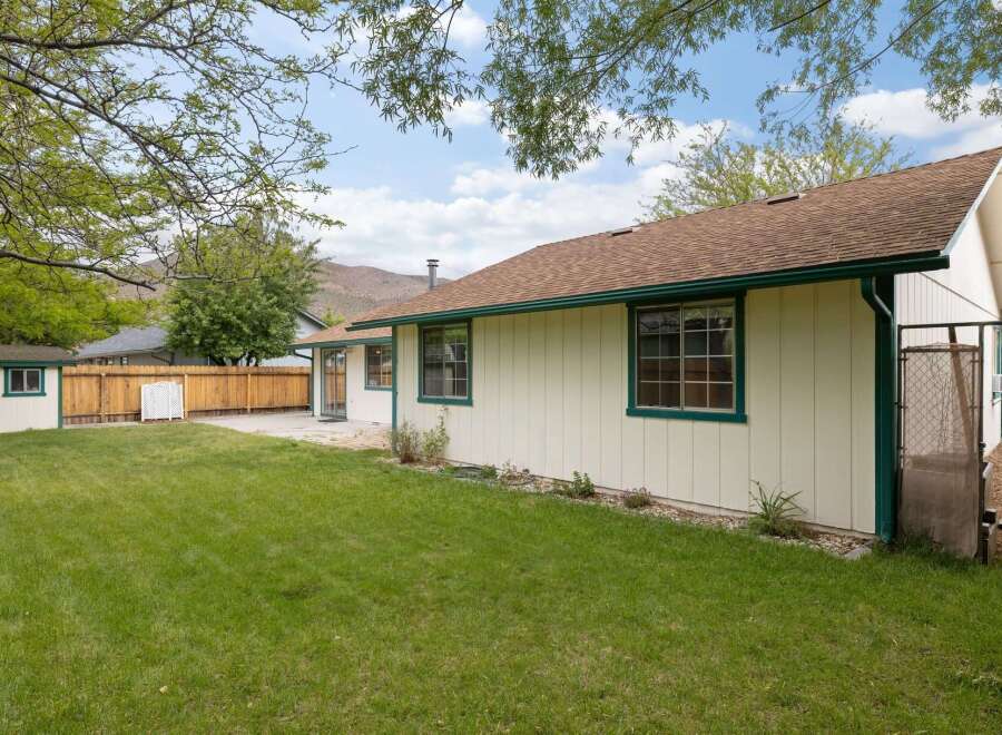 Enjoy the spacious backyard with a well-maintained lawn, perfect for outdoor activities and relaxation.