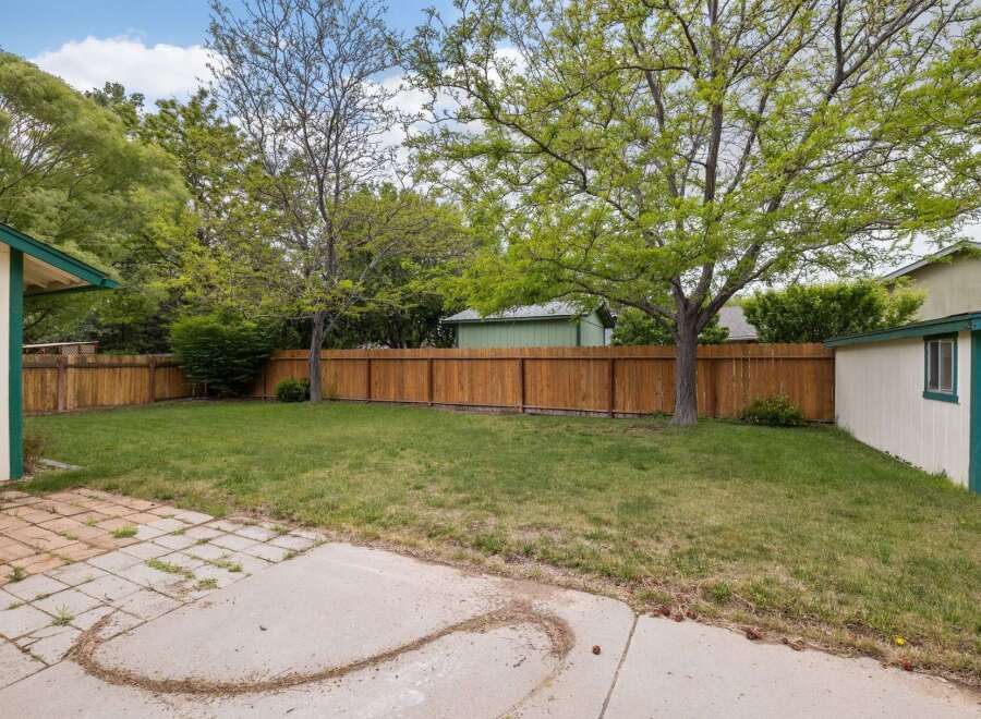 Enjoy this spacious backyard with a well-maintained lawn, perfect for outdoor activities and relaxation.
