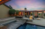 Experience luxurious outdoor living with this stunning backyard oasis, featuring a sparkling pool and a modern wooden deck perfect for relaxation and entertaining.