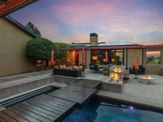Experience luxurious outdoor living with this stunning backyard oasis, featuring a sparkling pool and a modern wooden deck perfect for relaxation and entertaining.