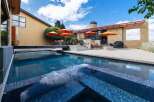 Experience luxury outdoor living with this stunning backyard oasis, featuring a sparkling swimming pool and integrated spa perfect for relaxation and entertainment.