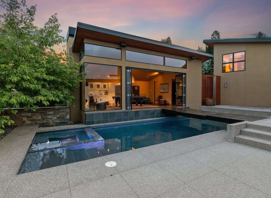 Experience modern luxury with this stunning property featuring a sleek design and an inviting swimming pool.