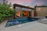Experience modern luxury with this stunning property featuring a sleek design and an inviting swimming pool.