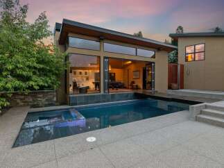 Experience modern luxury with this stunning property featuring a sleek design and an inviting swimming pool.