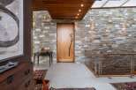 This entryway features a striking stone accent wall that adds natural texture and warmth to the space.