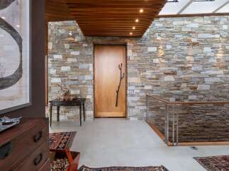 This entryway features a striking stone accent wall that adds natural texture and warmth to the space.