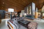 Experience luxury living in this stunning modern home featuring a dramatic floor-to-ceiling fireplace as the centerpiece of the living area.