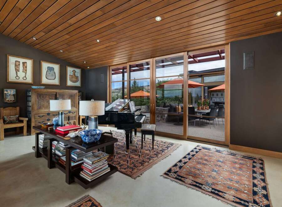 Experience luxury living in this stunning room featuring a grand piano and elegant decor.
