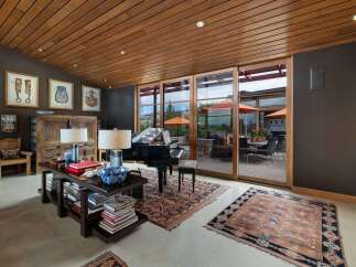 Experience luxury living in this stunning room featuring a grand piano and elegant decor.