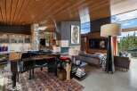 Experience luxury living in this stunning open-concept great room, featuring a grand piano and a modern fireplace.