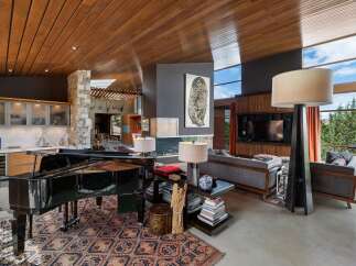 Experience luxury living in this stunning open-concept great room, featuring a grand piano and a modern fireplace.