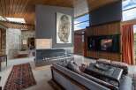 Experience luxury living in this stunning modern home featuring a dramatic double-sided fireplace as the centerpiece of the living area.