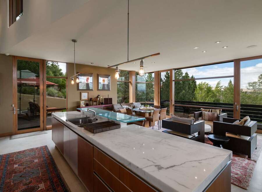 Experience modern living in this stunning open-concept home, featuring a gourmet kitchen with a marble island and sleek cabinetry.