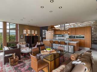 Experience luxury living in this open-concept home featuring a gourmet kitchen with custom wood cabinetry and a spacious island perfect for entertaining.