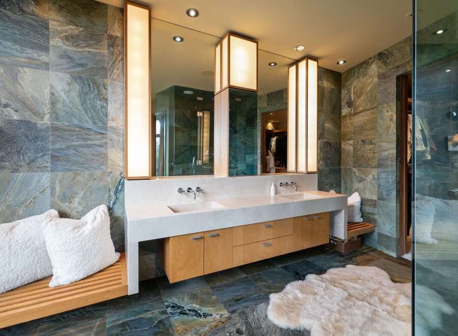 Experience luxury in this stunning master bathroom, featuring a spacious double vanity with sleek faucets and ample storage.