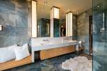 Experience luxury in this stunning master bathroom, featuring a spacious double vanity with sleek faucets and ample storage.