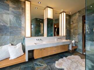 Experience luxury in this stunning master bathroom, featuring a spacious double vanity with sleek faucets and ample storage.