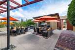 Experience luxurious outdoor living with this stunning patio featuring a dining set and a comfortable lounge area, perfect for entertaining.