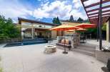 Experience luxurious outdoor living with this stunning patio featuring a sparkling swimming pool and a cozy fire pit.